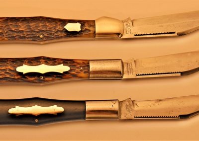 Top: Schatt & Morgan, folding hunter, 1 blade, jigged bone handles, brass liners, NS bolsters, no etch, X w/wings S M TITUSVILLE PA tang stamp, 5-1/4”, Center: Schatt & Morgan, folding hunter, 1 blade, jigged bone handles, brass liners, NS bolsters, no etch, block SCHATT & MORGAN CUTLERY CO TITUSVILLE PA tang stamp, 5-1/4”, Bottom: Schatt & Morgan, folding hunter, 1 blade, ebony handles, brass liners, NS bolsters, no etch, block SCHATT & MORGAN CUTLERY CO TITUSVILLE PA tang stamp, 5-1/4”