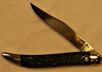 "#25, Queen, Jet push button w/out safety lock, 1 blade, rough black Micarta handles, brass liners, NS bolsters, no etch, big Q tang stamp w/PAT PENDING on back of blade, 5”"
