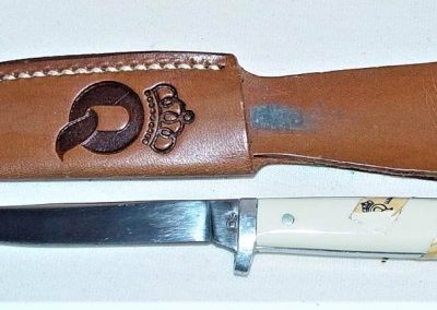 "#85, Queen, hunting knife, imitation ivory handles w/paper sticker, no etch, Q tang stamp w/STAINLESS on back, 3”"