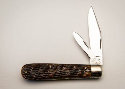 "Queen City, swell-end, 1-blade, sawn and picked brown bone handles, steel liners, NS bare head bolster, block Queen City stamp. Similar to #36 but not a lockback. 4 1/2”"