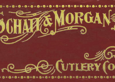 "Schatt & Morgan cutlery label, red background with yellow type"